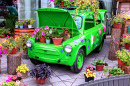 Цветы с зеленым ретро-автомобилем