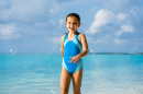 195849979-happy-child-having-fun-on-beach-playful-kid-person